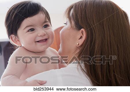 Hispanic mother carrying baby boy View Large Photo Image Picture - Hispanic mother carrying baby boy. Fotosearch