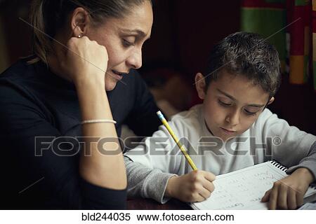Hispanic mother watching son practicing writing alphabet View Large Photo Image Stock Photography - Hispanic mother watching son practicing writing alphabet. Fotosearch