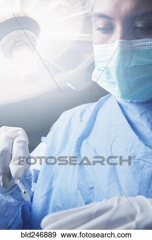 Hispanic surgeon holding scalpel View Large Photo Image Stock Photo - Hispanic surgeon holding scalpel. Fotosearch