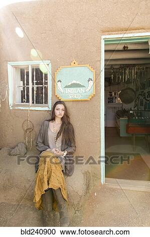Hispanic teenage girl sitting near doorway to shop View Large Photo Image Stock Image - Hispanic teenage girl sitting near doorway to shop. Fotosearch