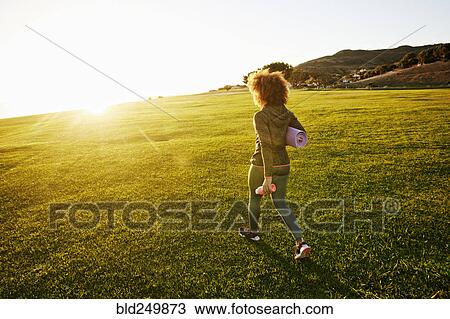 Hispanic woman carrying exercise mat in sunny field View Large Photo Image Stock Image - Hispanic woman carrying exercise mat in sunny field. Fotosearch