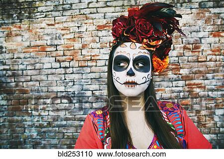 Hispanic woman near brick wall wearing skull face paint View Large Photo Image Stock Image - Hispanic woman near brick wall wearing skull face paint. Fotosearch