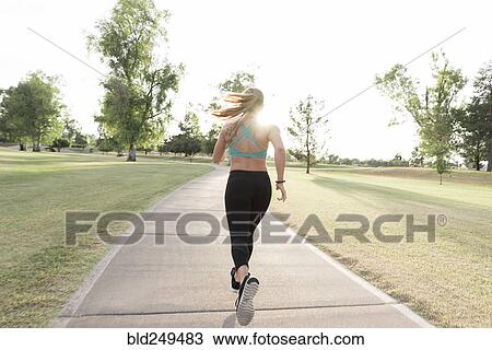 Hispanic woman running on path in park View Large Photo Image Stock Image - Hispanic woman running on path in park. Fotosearch