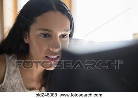 Stock Photo - Hispanic woman using computer. Fotosearch