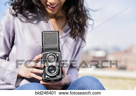 Hispanic woman using vintage camera View Large Photo Image Stock Image - Hispanic woman using vintage camera. Fotosearch