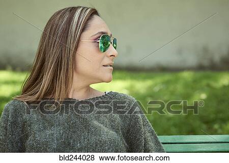 Stock Photo - Hispanic woman wearing sunglasses. Fotosearch