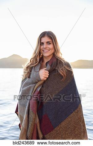 Hispanic woman wrapped in blanket at river View Large Photo Image Stock Photo - Hispanic woman wrapped in blanket at river. Fotosearch