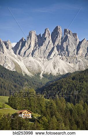 Stock Photo - House in remote mountain landscape, Funes, Trentino Alto Adige, Italy. Fotosearch