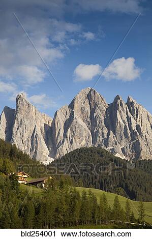 Stock Image - Houses in remote mountain landscape, Funes, Trentino Alto Adige, Italy. Fotosearch