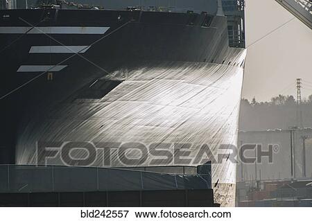 Stock Photo - Hull of ship at shipping port. Fotosearch