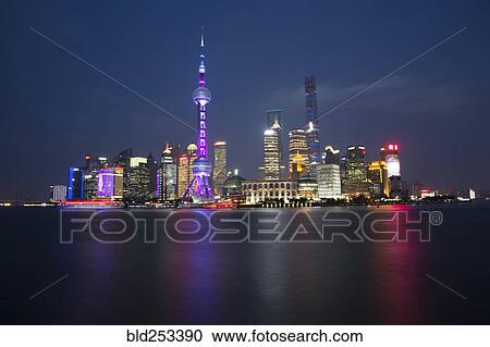 Stock Image - Illuminated city waterfront, Beijing, China. Fotosearch
