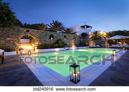 Stock Photograph - Illuminated swimming pool at night. Fotosearch