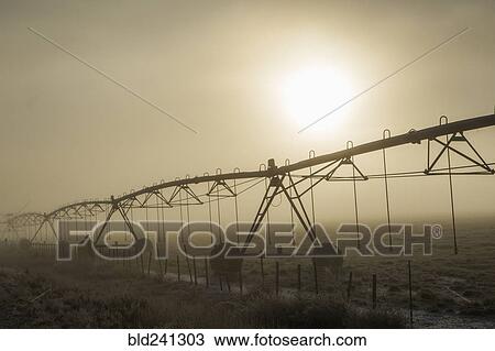 Irrigation equipment on farm in fog View Large Photo Image Stock Image - Irrigation equipment on farm in fog. Fotosearch