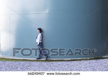 Japanese woman walking near storage tank View Large Photo Image Stock Photo - Japanese woman walking near storage tank. Fotosearch