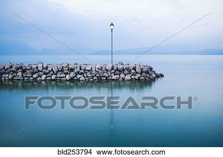 Lamp on stone breakwall in ocean View Large Photo Image Picture - Lamp on stone breakwall in ocean. Fotosearch