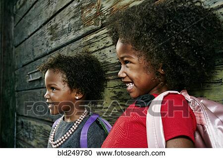 Laughing girls near wooden wall View Large Photo Image Stock Image - Laughing girls near wooden wall. Fotosearch