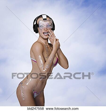 Stock Photo - Laughing woman cyborg using virtual reality goggles. Fotosearch