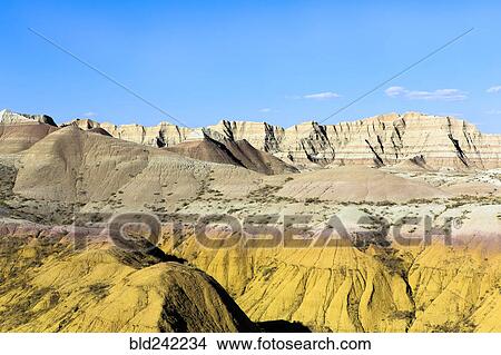 Picture - Layered rock formations under blue sky, Badlands National Park, South Dakota, United States. Fotosearch