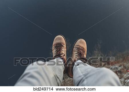 Legs of Caucasian man sitting at the edge of reservoir View Large Photo Image Picture - Legs of Caucasian man sitting at the edge of reservoir. Fotosearch