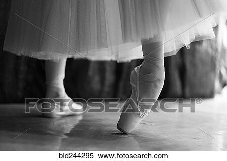 Stock Photography - Legs of woman stretching in ballet shoes. Fotosearch