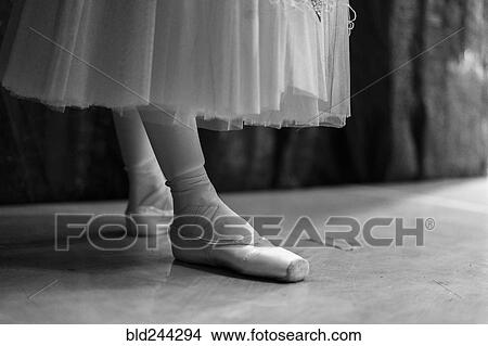 Picture - Legs of woman wearing ballet shoes. Fotosearch