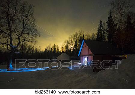 Stock Image - Light glowing in remote barn in winter. Fotosearch