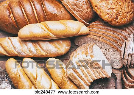 Stock Photo - Loaves and sliced bread on table. Fotosearch