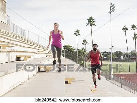 Man and woman running on bleachers View Large Photo Image Stock Image - Man and woman running on bleachers. Fotosearch