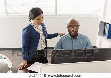 Man and woman working at computer in office View Large Photo Image Stock Photo - Man and woman working at computer in office. Fotosearch