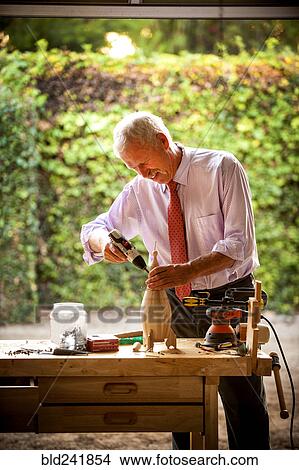Man building birdhouse in garage View Large Photo Image Picture - Man building birdhouse in garage. Fotosearch