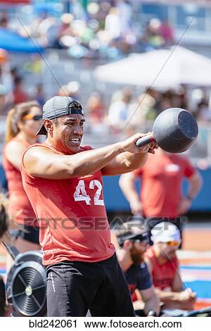 Man lifting kettlebell outdoors View Large Photo Image Stock Image - Man lifting kettlebell outdoors. Fotosearch