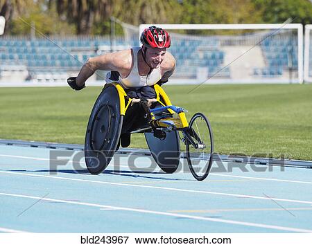 Stock Photo - Man racing in wheelchair on track. Fotosearch