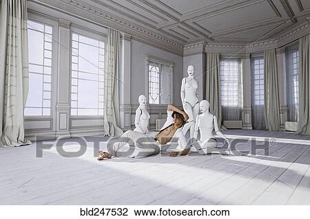 Man sitting on floor with women robots View Large Photo Image Stock Image - Man sitting on floor with women robots. Fotosearch