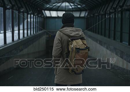 Man standing in tunnel carrying backpack View Large Photo Image Stock Photography - Man standing in tunnel carrying backpack. Fotosearch