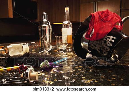 Stock Image - Martini, hat and cocktail shaker after New Year's Eve party. Fotosearch