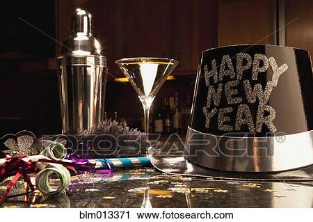 Stock Image - Martini, hat and cocktail shaker at New Year's Eve party. Fotosearch
