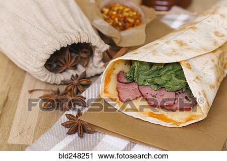Meat and melted cheese in wrap View Large Photo Image Stock Image - Meat and melted cheese in wrap. Fotosearch