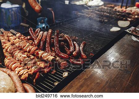 Stock Photograph - Meat cooking on grille. Fotosearch