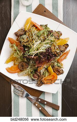 Meat with tomatoes and oranges on plate View Large Photo Image Stock Photograph - Meat with tomatoes and oranges on plate. Fotosearch