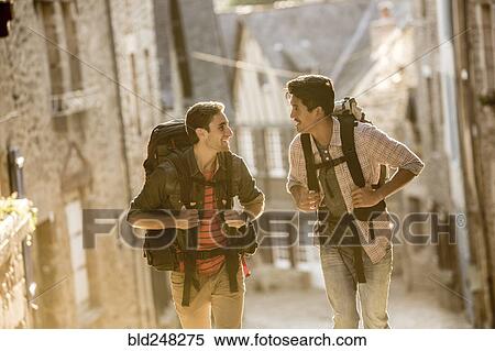 Stock Photography - Men backpacking in city. Fotosearch
