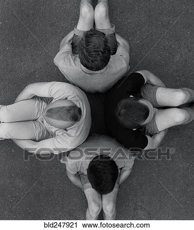 Men sitting back to back on ground View Large Photo Image Stock Image - Men sitting back to back on ground. Fotosearch