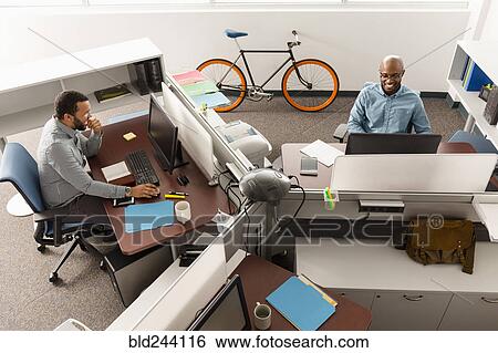 Stock Photograph - Men working at computers in office. Fotosearch