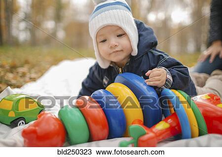 Middle Eastern baby boy playing with toys in park View Large Photo Image Stock Image - Middle Eastern baby boy playing with toys in park. Fotosearch
