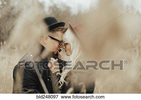 Stock Photo - Middle Eastern couple rubbing noses in field. Fotosearch