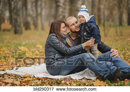 Middle Eastern couple sitting in park with baby son in autumn View Large Photo Image Stock Photo - Middle Eastern couple sitting in park with baby son in autumn. Fotosearch