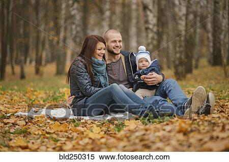 Middle Eastern couple sitting in park with baby son in autumn View Large Photo Image Stock Photography - Middle Eastern couple sitting in park with baby son in autumn. Fotosearch