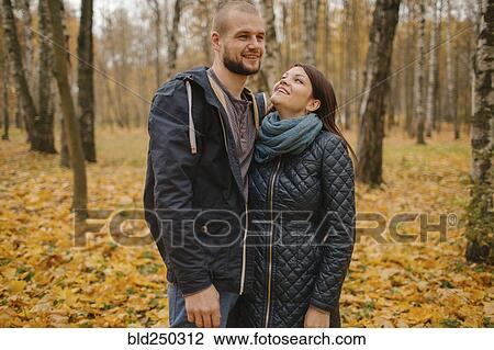 Stock Image - Middle Eastern couple standing in park in autumn. Fotosearch