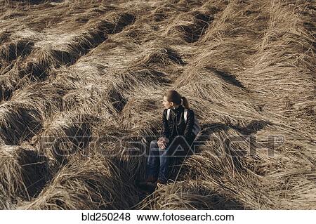 Middle Eastern woman resting in tall grass View Large Photo Image Stock Photo - Middle Eastern woman resting in tall grass. Fotosearch