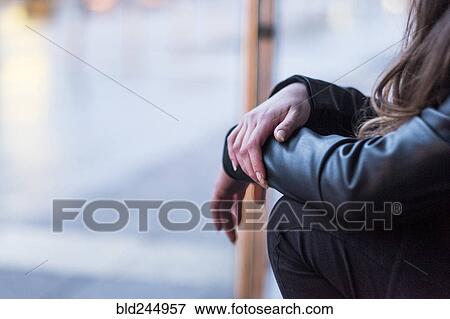 Midsection of Caucasian woman sitting outdoors View Large Photo Image Stock Photo - Midsection of Caucasian woman sitting outdoors. Fotosearch