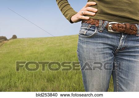 Midsection of Mixed Race woman standing in field View Large Photo Image Stock Image - Midsection of Mixed Race woman standing in field. Fotosearch